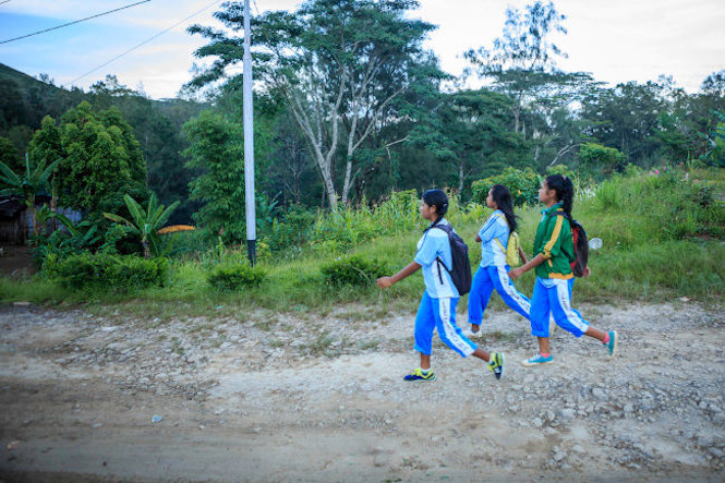 image of girls walking in rural setting